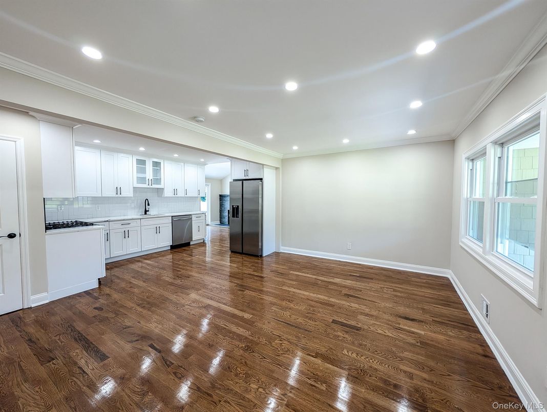 Empty room, Interior, Kitchen, Recessed Lighting, Stainless Steel Appliances, Wood Texture Flooring