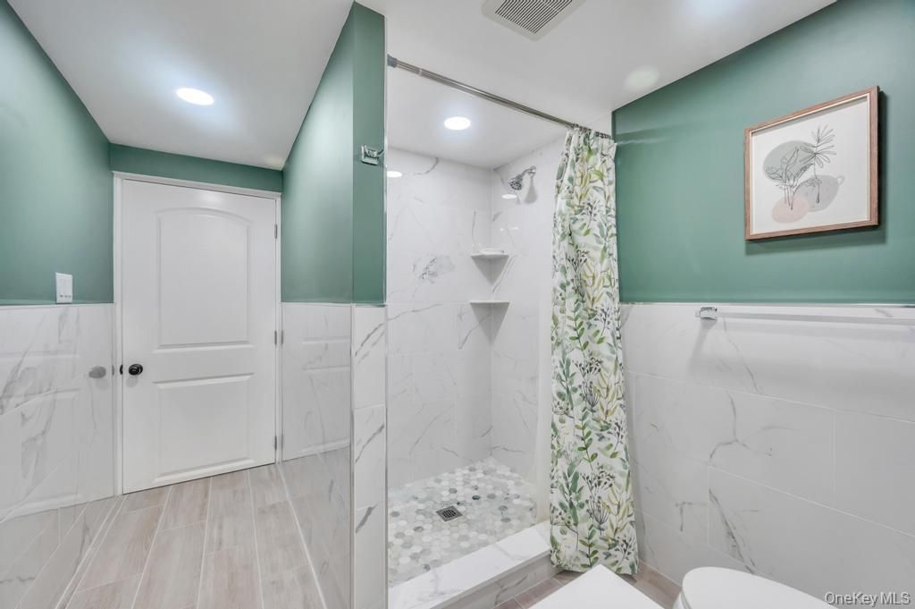 Bathroom, Glass Shower, Interior, Marble Walls, Recessed Lighting, Wood Texture Flooring