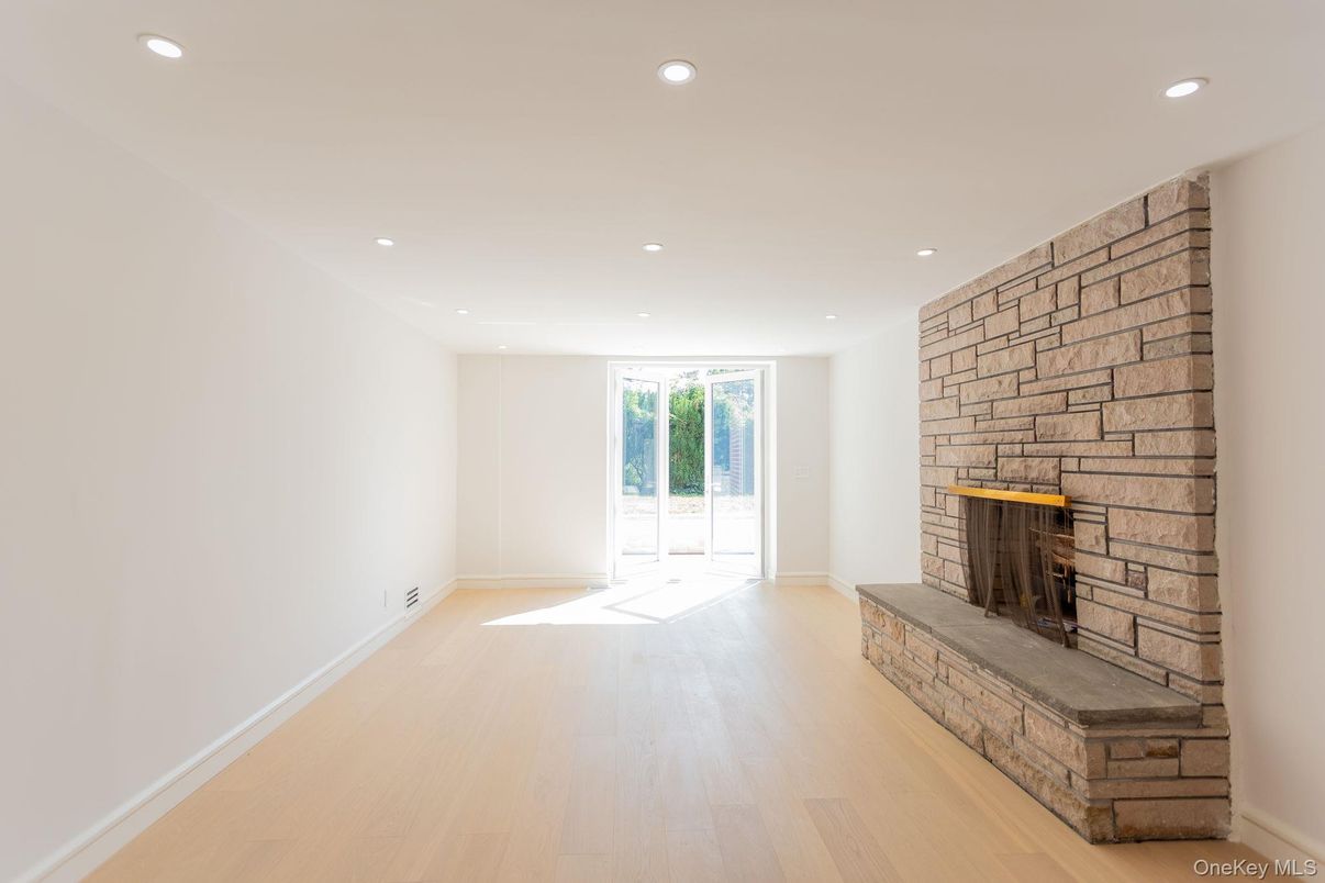 Empty room, Fireplace, Interior, Recessed Lighting, Stone Walls, Wood Texture Flooring