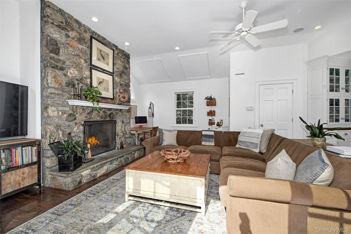 Fireplace, Interior, Living room, Recessed Lighting, Stone Walls, Wood Texture Flooring