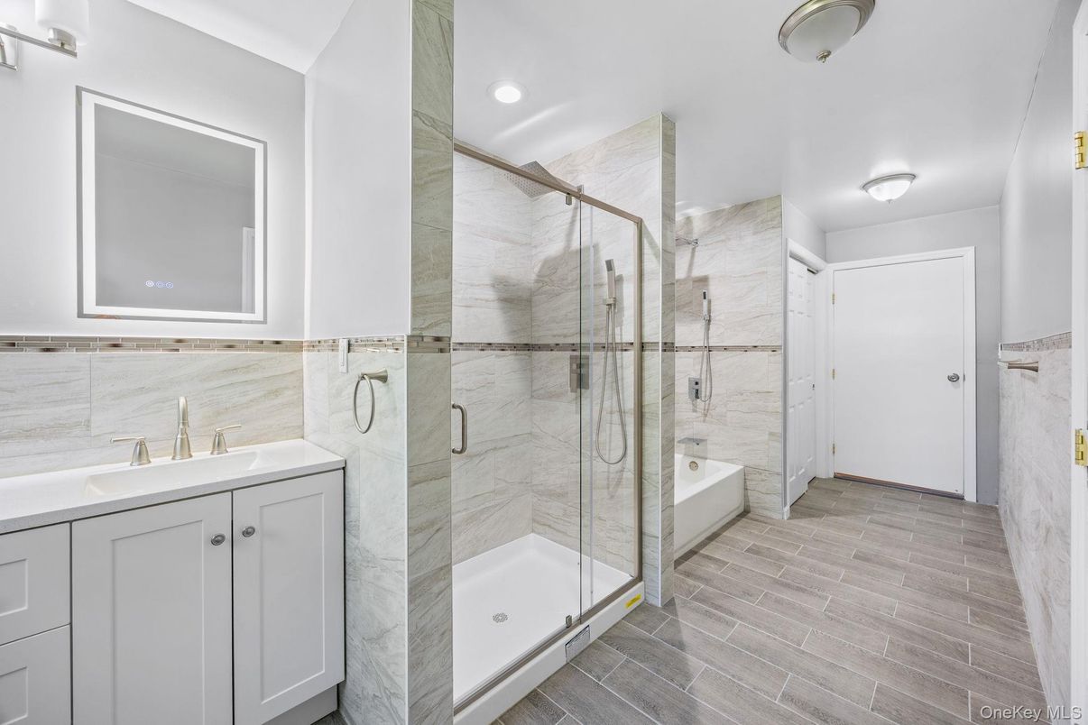 Bathroom, Glass Shower, Interior, Marble Walls, Recessed Lighting, Wood Texture Flooring