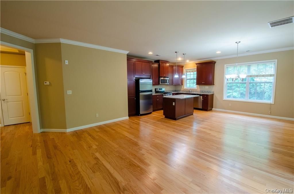 Empty room, Interior, Kitchen, Pendant Lights, Recessed Lighting, Stainless Steel Appliances, Wood Texture Flooring
