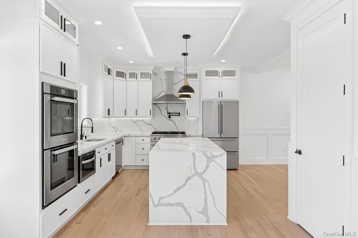 Interior, Kitchen, Marble Walls, Pendant Lights, Recessed Lighting, Stainless Steel Appliances, Wood Texture Flooring