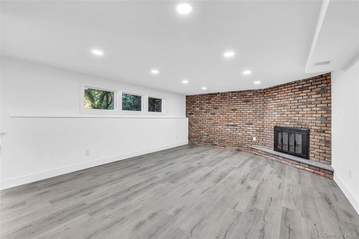 Empty room, Fireplace, Interior, Recessed Lighting, Stone Walls, Wood Texture Flooring