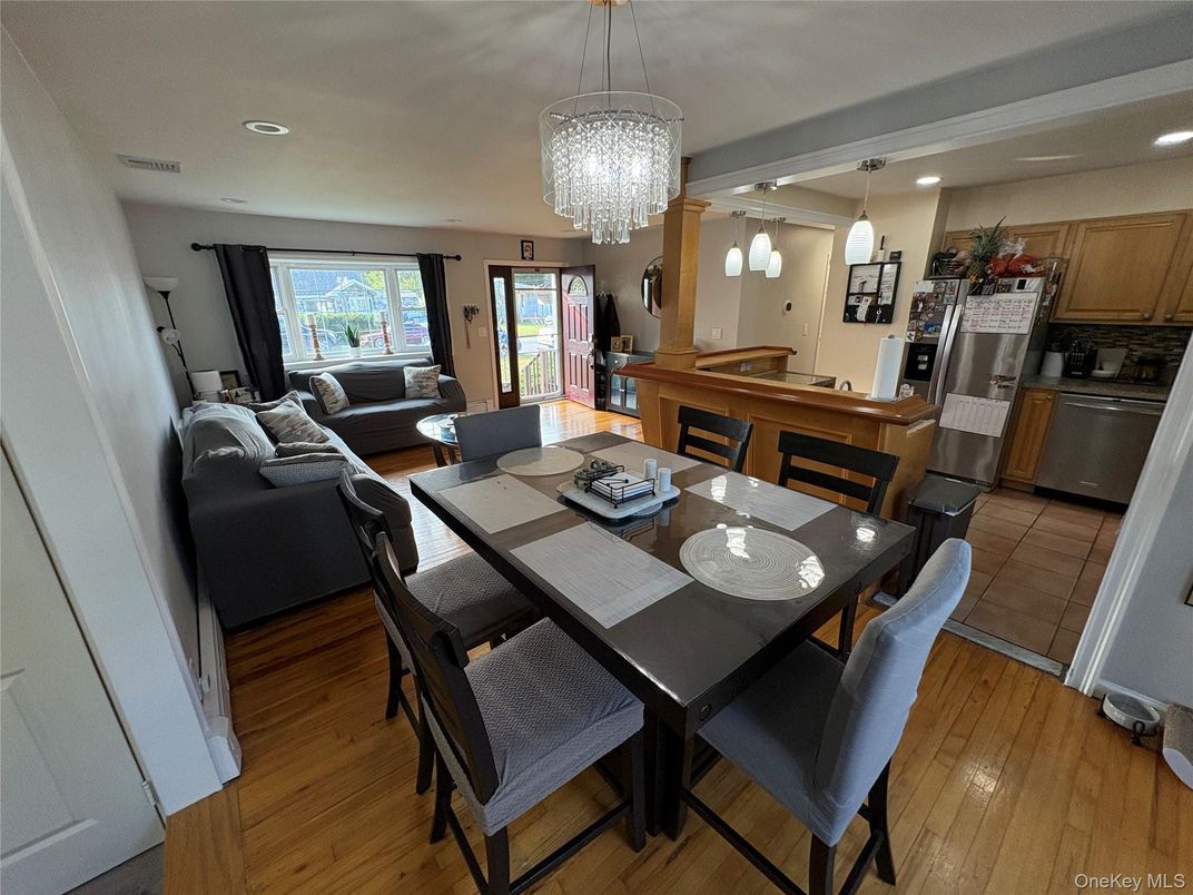 Chandelier, Dining room, Interior, Kitchen, Living room, Pendant Lights, Recessed Lighting, Stainless Steel Appliances, Wood Texture Flooring