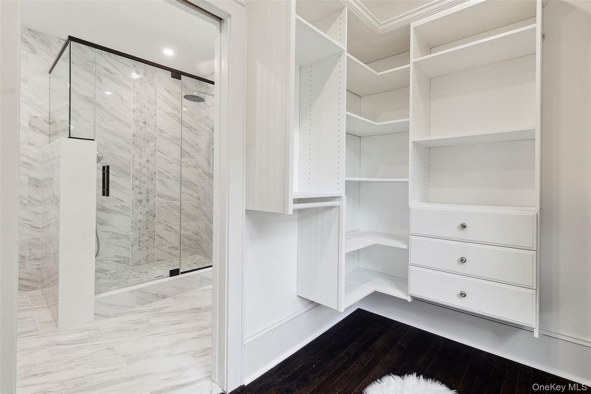 Bathroom, Glass Shower, Interior, Marble, Marble Walls, Recessed Lighting, Walk-in Closets, Wood Texture Flooring