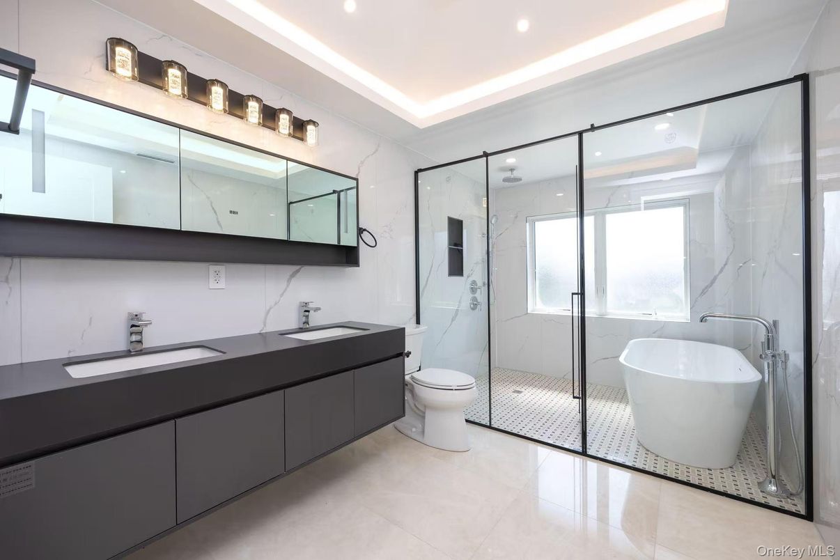 Bathroom, Dual Sink Vanities, Free Standing Baths, Glass Shower, Interior, Marble Walls, Recessed Lighting