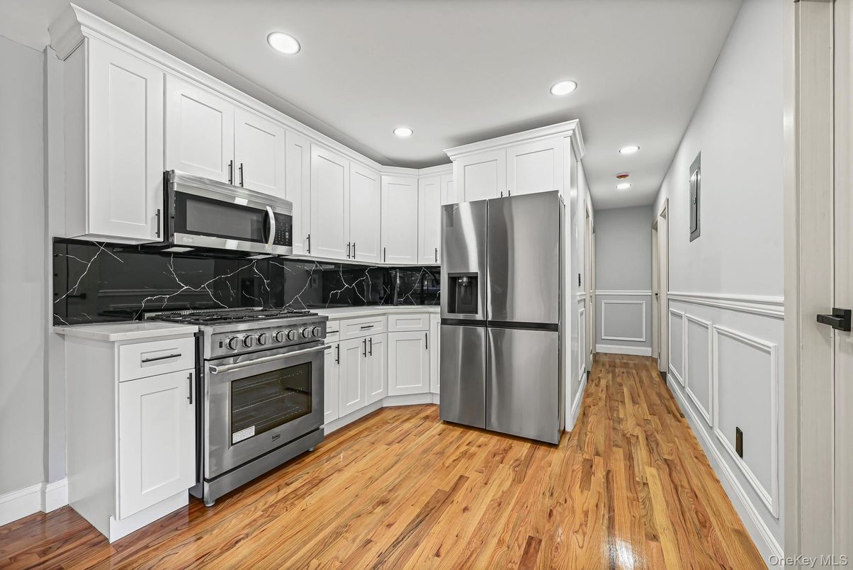 Interior, Kitchen, Marble Walls, Recessed Lighting, Stainless Steel Appliances, Wood Texture Flooring