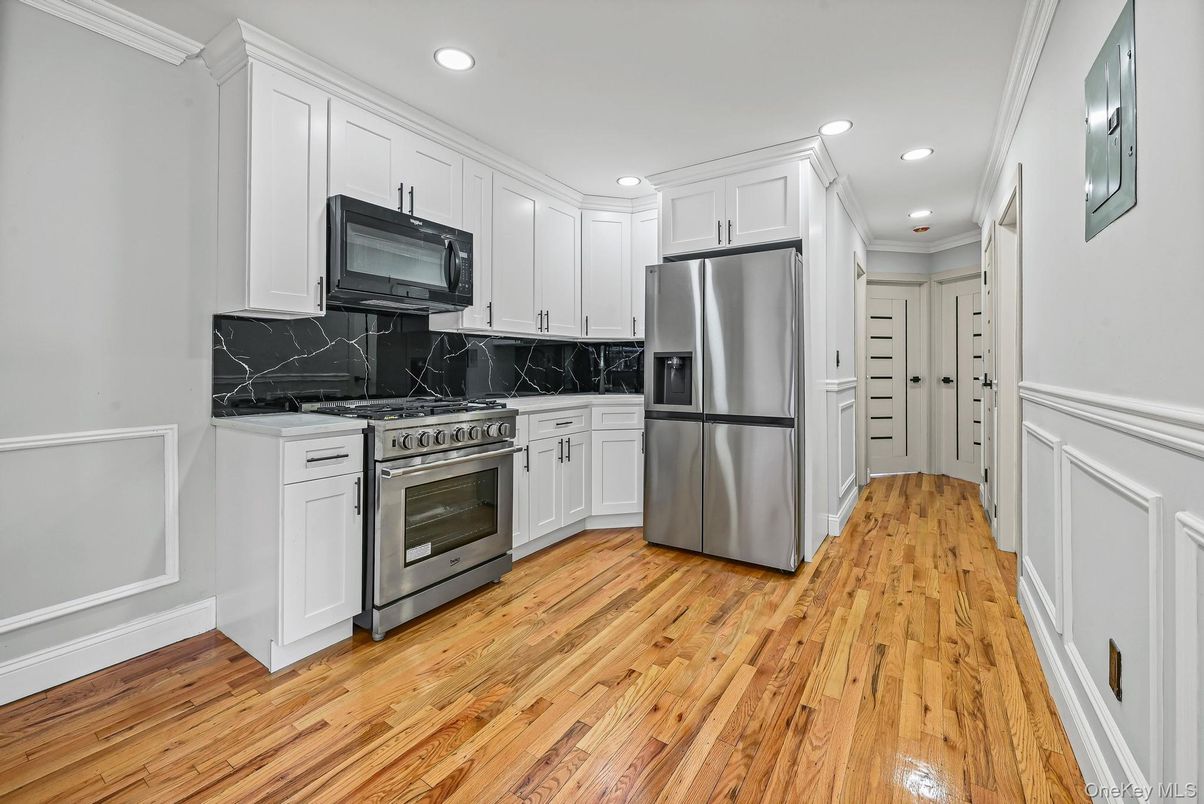 Interior, Kitchen, Marble Walls, Recessed Lighting, Stainless Steel Appliances, Wood Texture Flooring