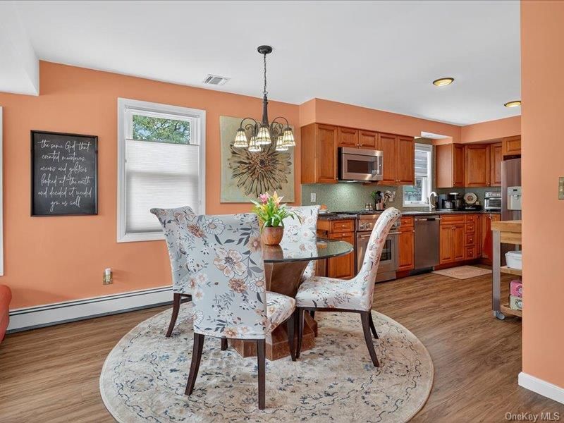 Chandelier, Dining room, Interior, Kitchen, Pendant Lights, Recessed Lighting, Stainless Steel Appliances, Wood Texture Flooring