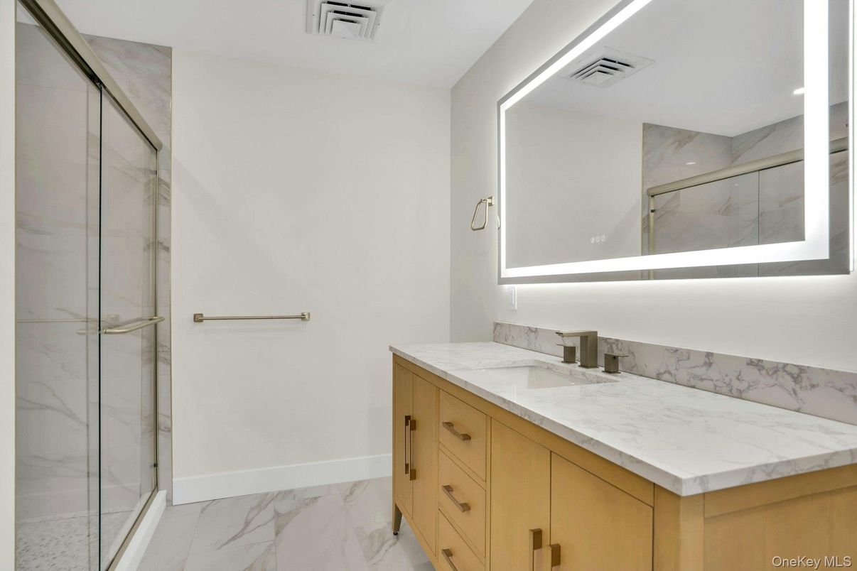 Bathroom, Dual Sink Vanities, Glass Shower, Interior, Marble, Marble Walls, Recessed Lighting