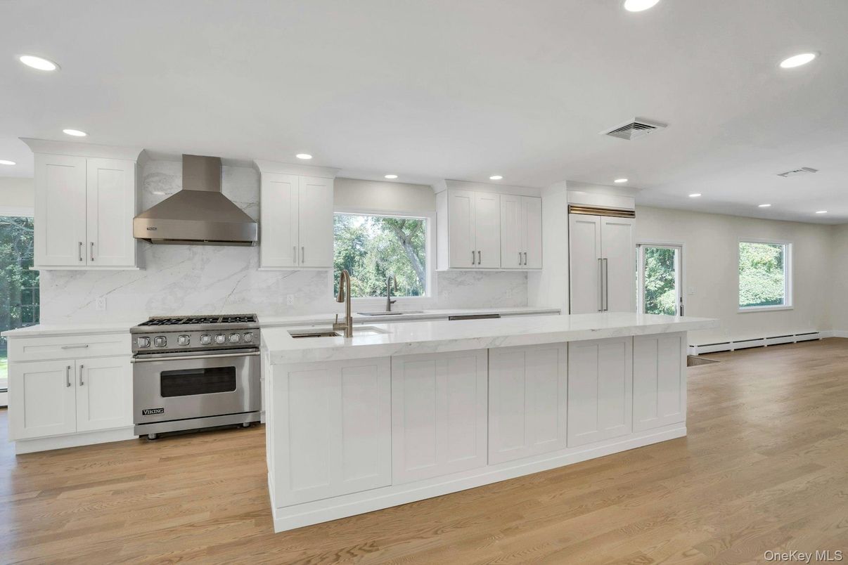Interior, Kitchen, Marble Walls, Recessed Lighting, Stainless Steel Appliances, Wood Texture Flooring