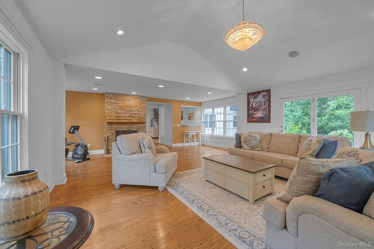 Chandelier, Fireplace, Interior, Living room, Recessed Lighting, Stone Walls, Wood Texture Flooring