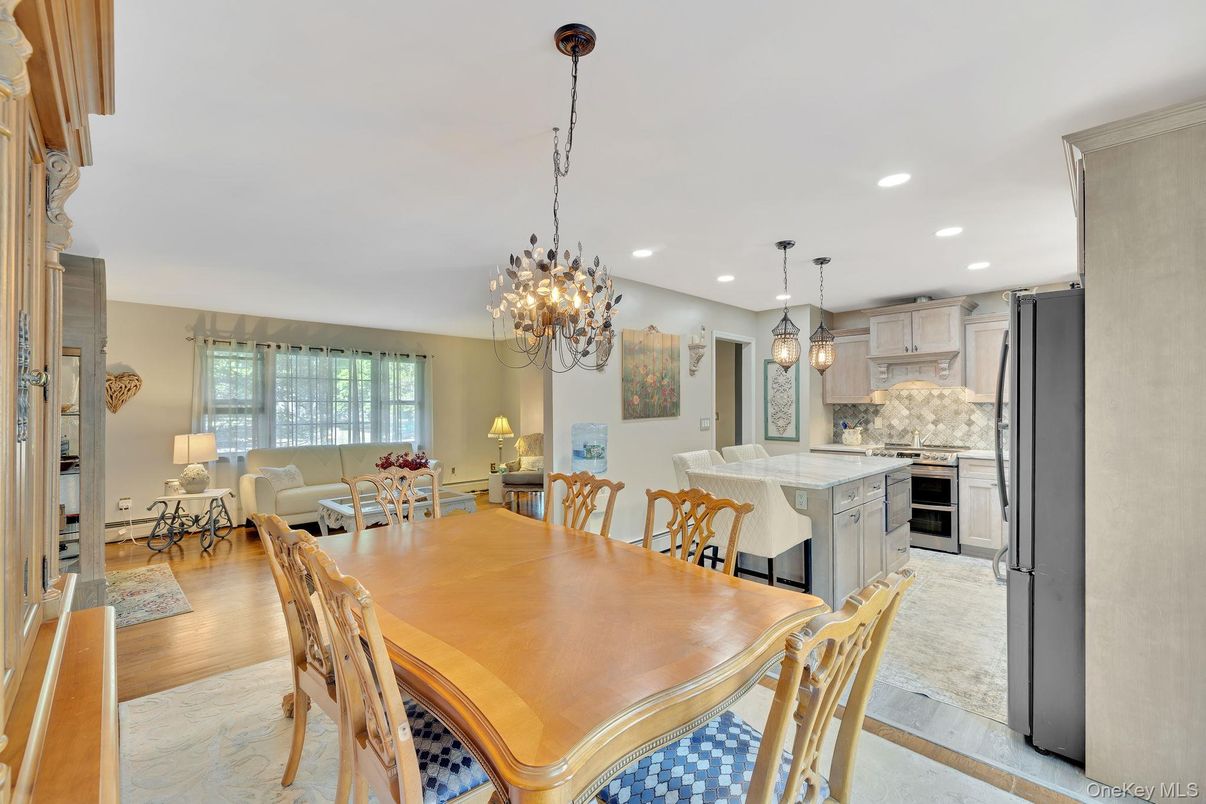Chandelier, Dining room, Interior, Kitchen, Living room, Pendant Lights, Recessed Lighting, Stainless Steel Appliances, Wood Texture Flooring