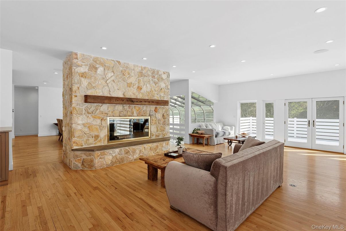 Fireplace, Interior, Living room, Recessed Lighting, Stone Walls, Wood Texture Flooring