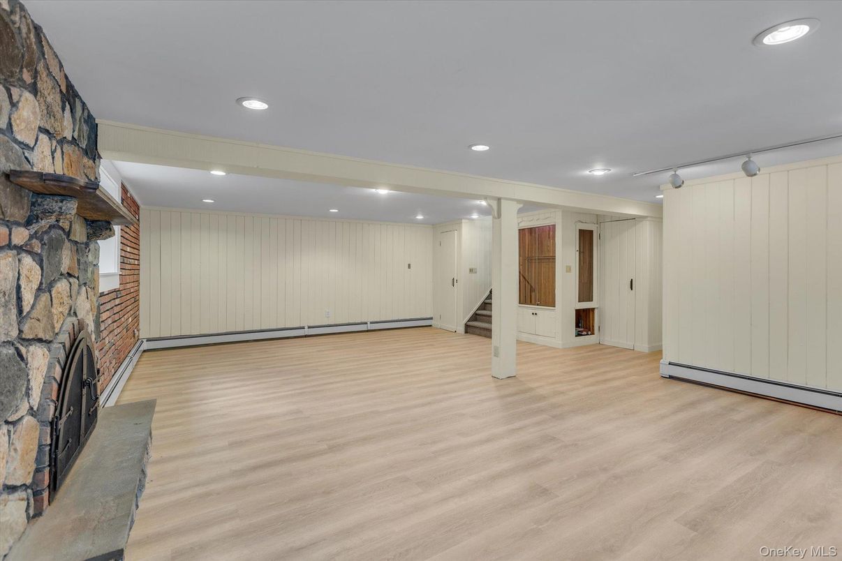Empty room, Fireplace, Interior, Recessed Lighting, Stone Walls, Wood Texture Flooring