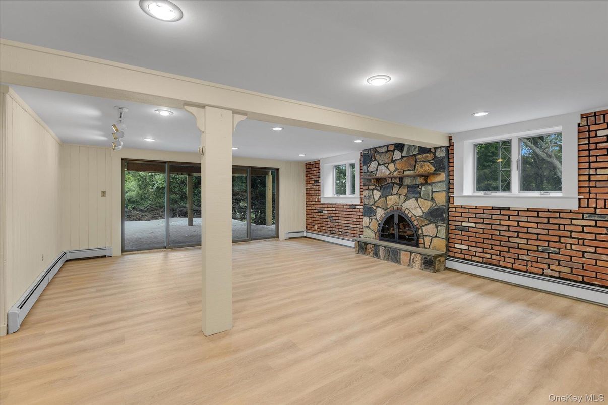 Empty room, Fireplace, Interior, Recessed Lighting, Stone Walls, Wood Texture Flooring