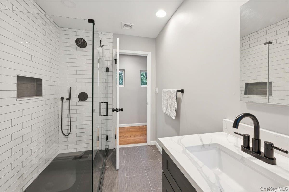 Bathroom, Dual Sink Vanities, Glass Shower, Interior, Recessed Lighting, Wood Texture Flooring