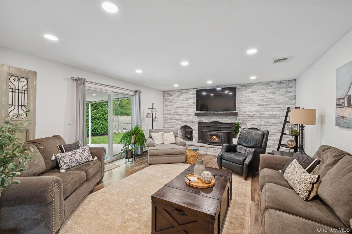 Fireplace, Interior, Living room, Recessed Lighting, Stone Walls, Wood Texture Flooring