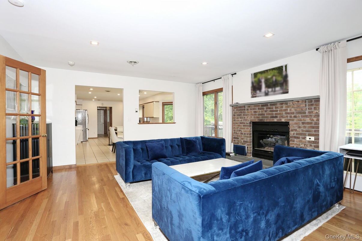 Fireplace, Interior, Living room, Recessed Lighting, Stone Walls, Wood Texture Flooring