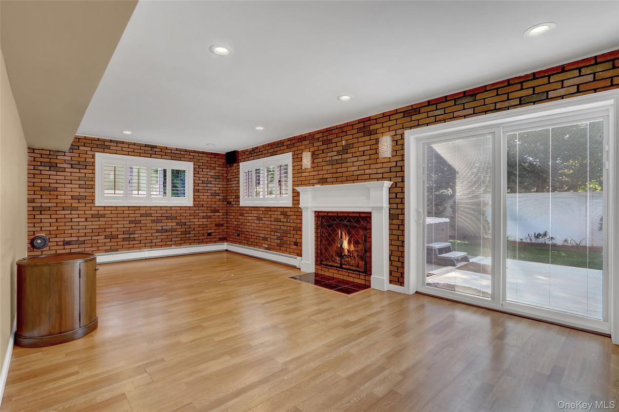 Empty room, Fireplace, Interior, Recessed Lighting, Stone Walls, Wood Texture Flooring