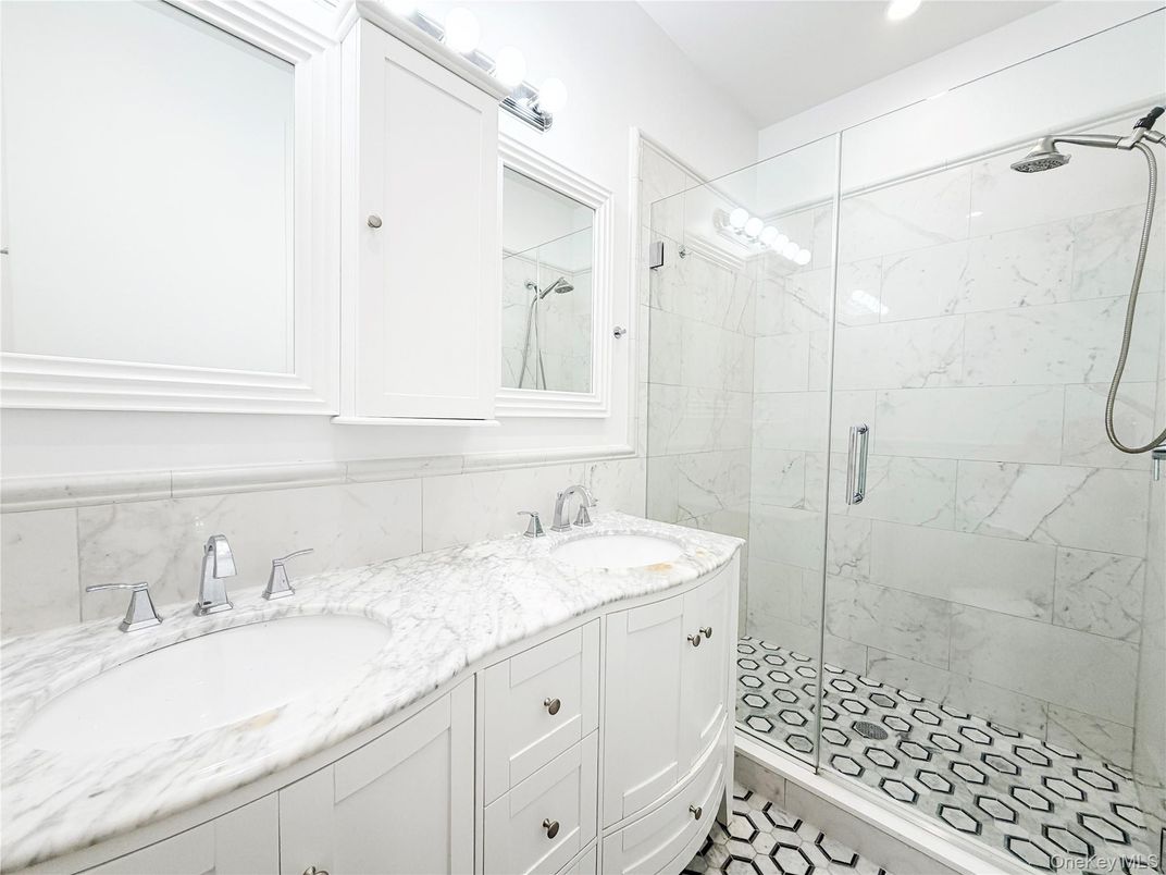Bathroom, Dual Sink Vanities, Glass Shower, Interior, Marble Walls, Recessed Lighting