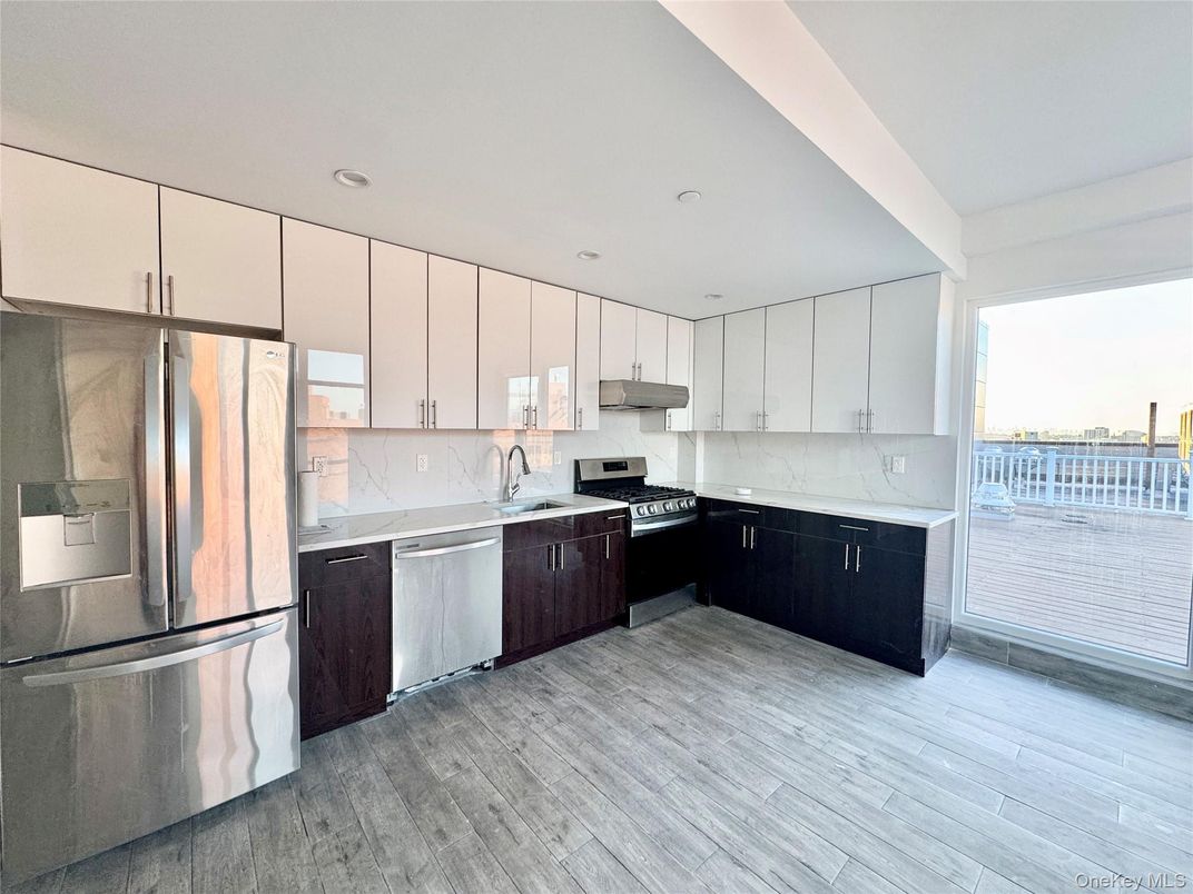 Interior, Kitchen, Marble Walls, Recessed Lighting, Stainless Steel Appliances, Wood Texture Flooring