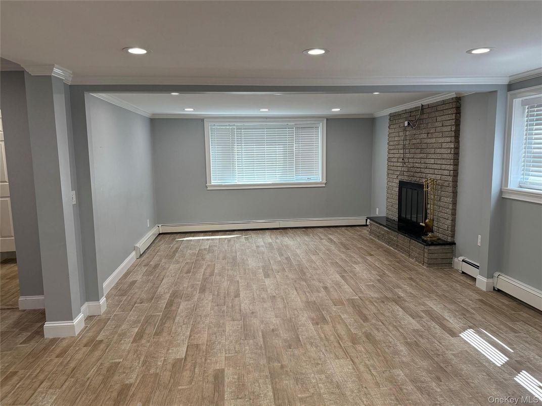 Empty room, Fireplace, Interior, Recessed Lighting, Stone Walls, Wood Texture Flooring