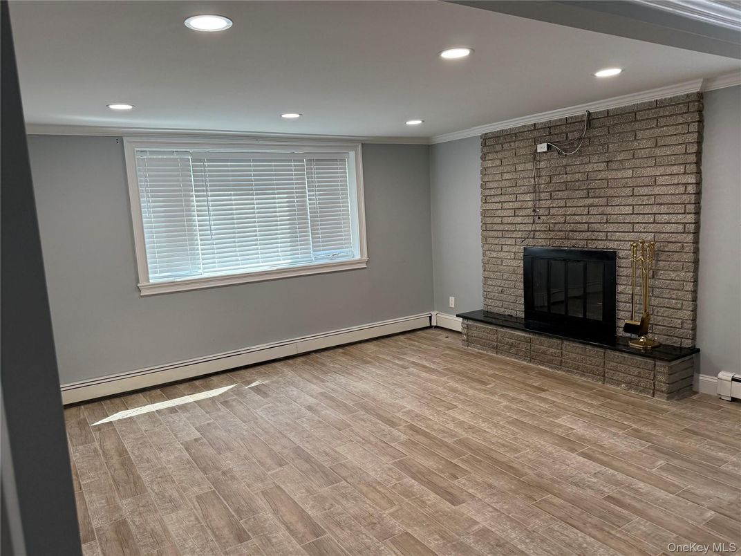 Empty room, Fireplace, Interior, Recessed Lighting, Stone Walls, Wood Texture Flooring