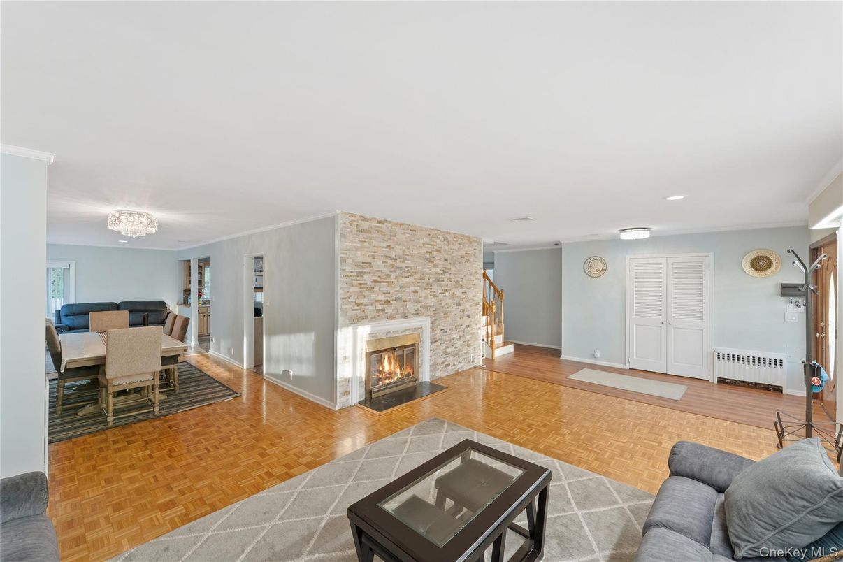 Chandelier, Dining room, Fireplace, Interior, Living room, Recessed Lighting, Stone Walls, Wood Texture Flooring