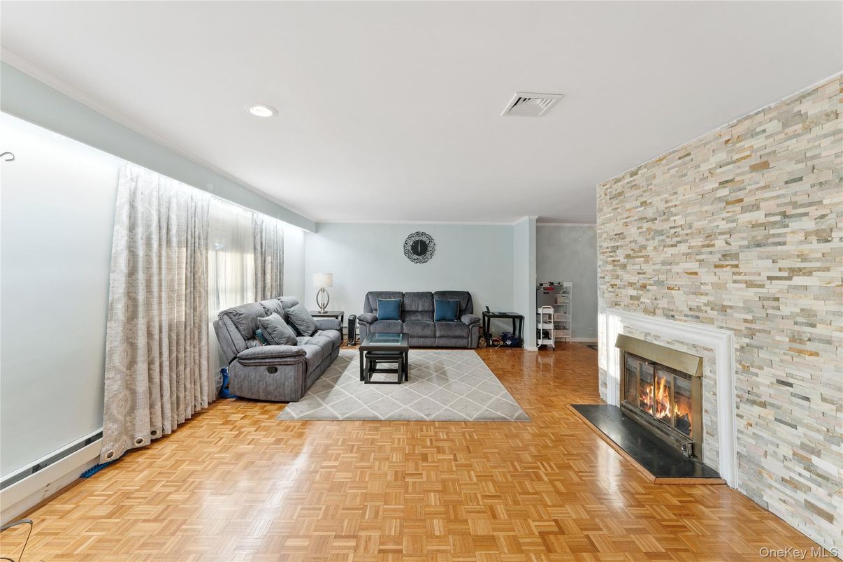 Fireplace, Interior, Living room, Recessed Lighting, Stone Walls, Wood Texture Flooring