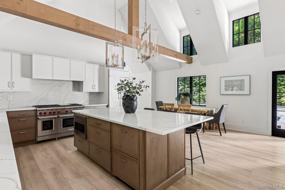Chandelier, Dining room, Interior, Kitchen, Marble Walls, Pendant Lights, Stainless Steel Appliances, Wooden Beams, Wood Texture Flooring