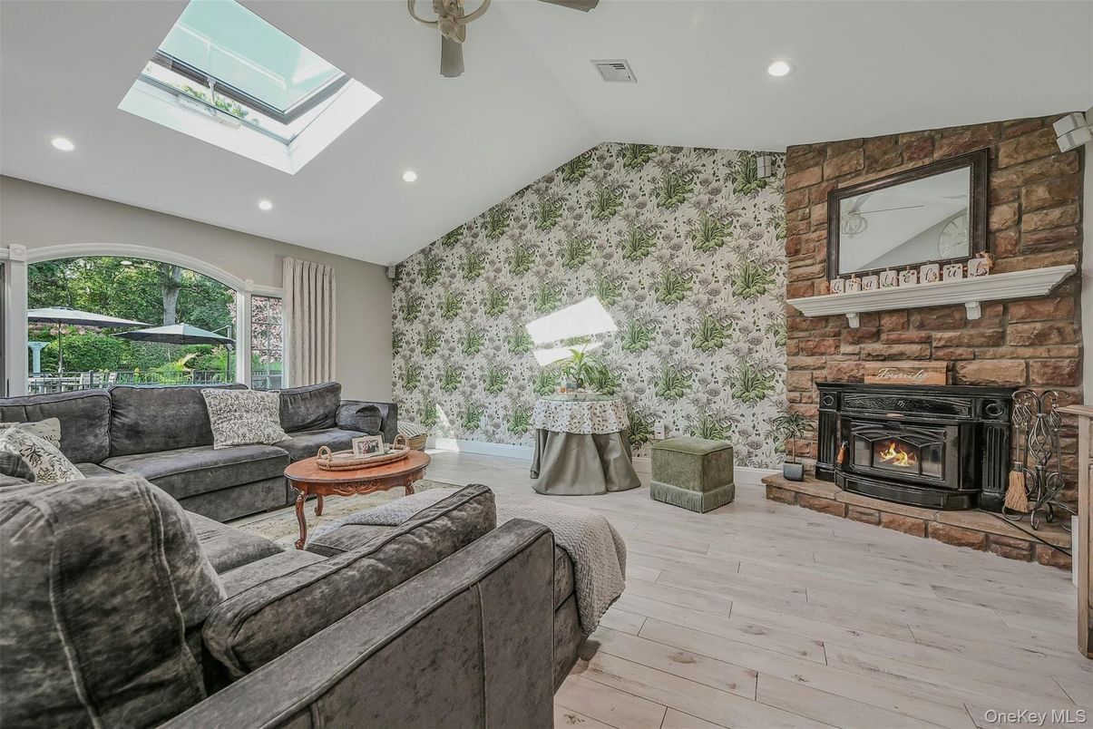 Fireplace, Interior, Living room, Recessed Lighting, Stone Walls, Wood Texture Flooring