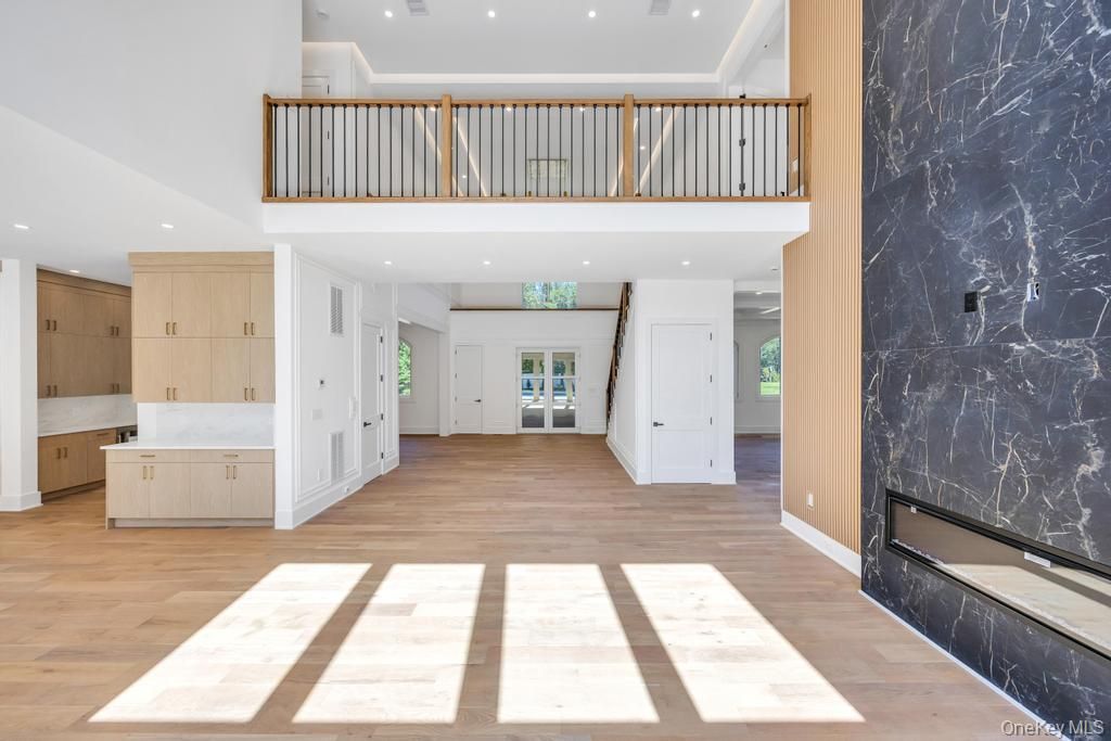 Fireplace, Interior, Marble Walls, Recessed Lighting, Wood Texture Flooring