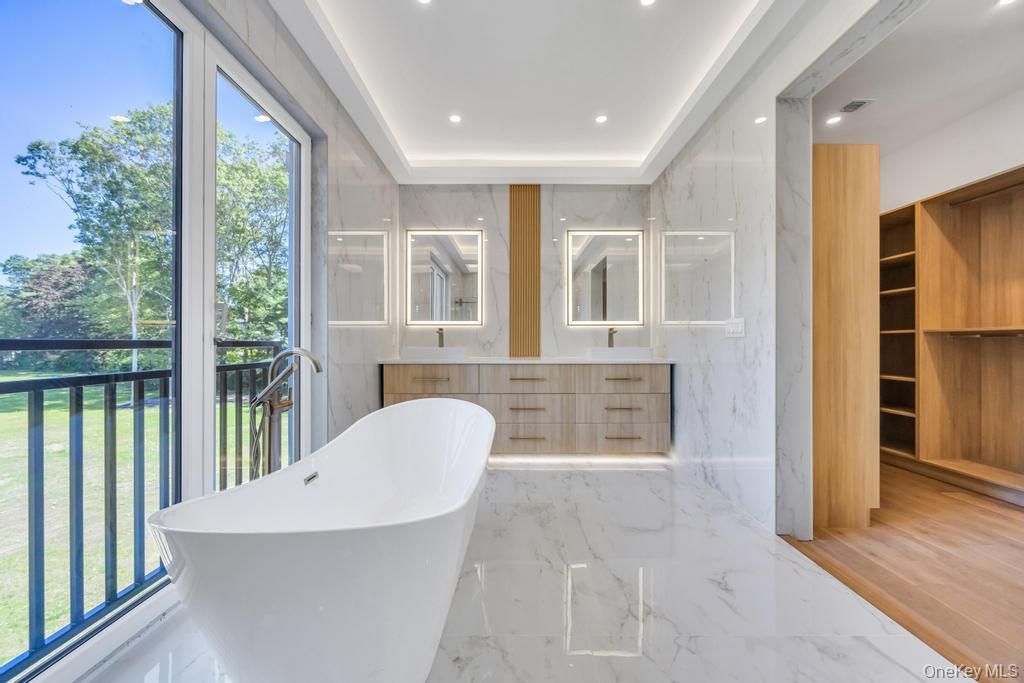 Bathroom, Dual Sink Vanities, Free Standing Baths, Interior, Marble, Marble Walls, Recessed Lighting, Wood Texture Flooring