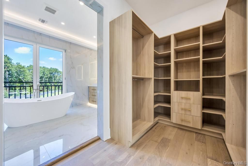 Bathroom, Free Standing Baths, Interior, Marble, Marble Walls, Recessed Lighting, Wood Texture Flooring