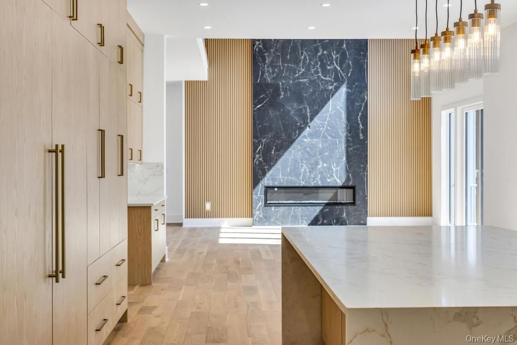 Fireplace, Interior, Marble Walls, Pendant Lights, Recessed Lighting, Wood Texture Flooring
