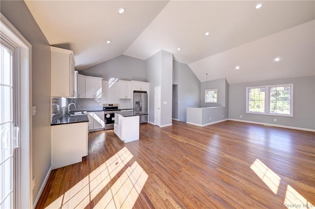 Empty room, Interior, Kitchen, Recessed Lighting, Stainless Steel Appliances, Wood Texture Flooring