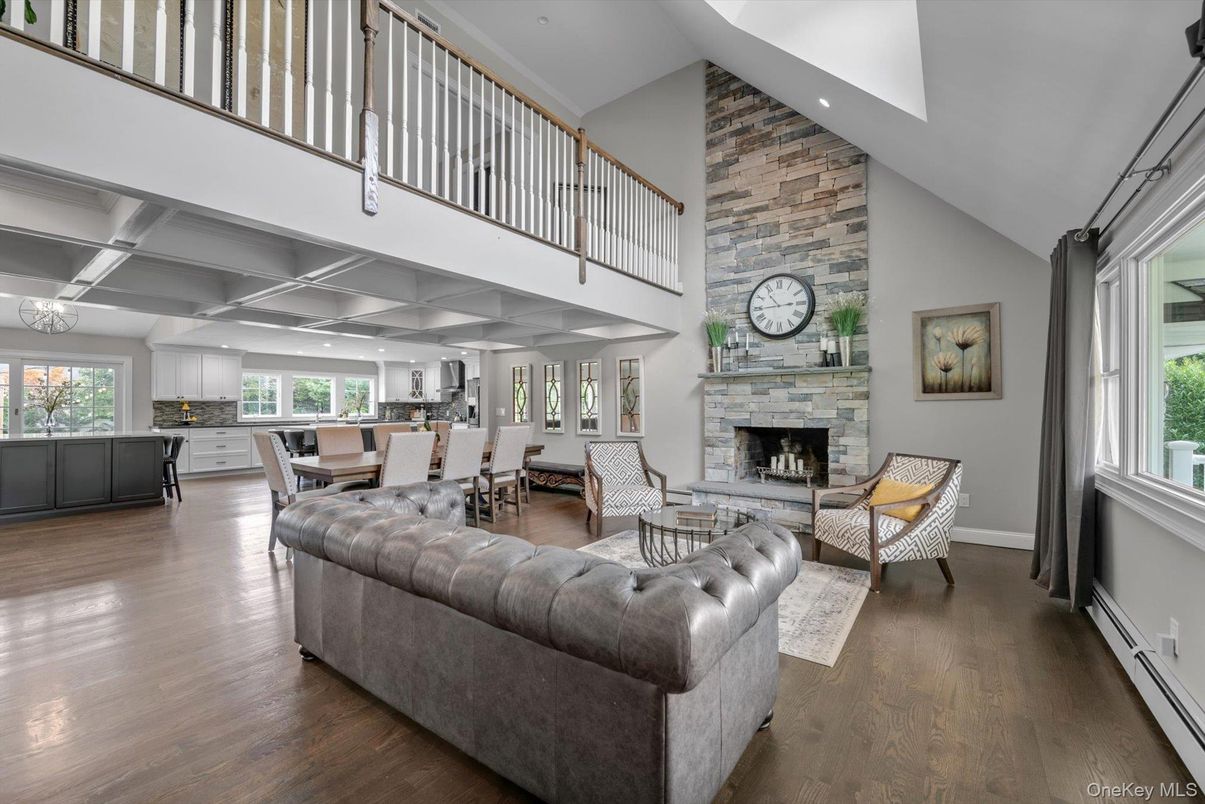 Dining room, Fireplace, Interior, Living room, Recessed Lighting, Stone Walls, Wood Texture Flooring