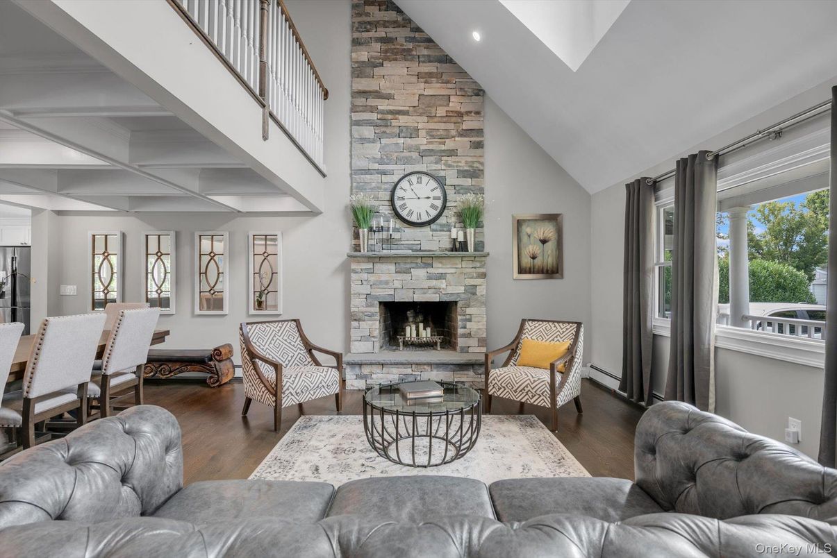 Dining room, Fireplace, Interior, Living room, Recessed Lighting, Stone Walls, Wood Texture Flooring