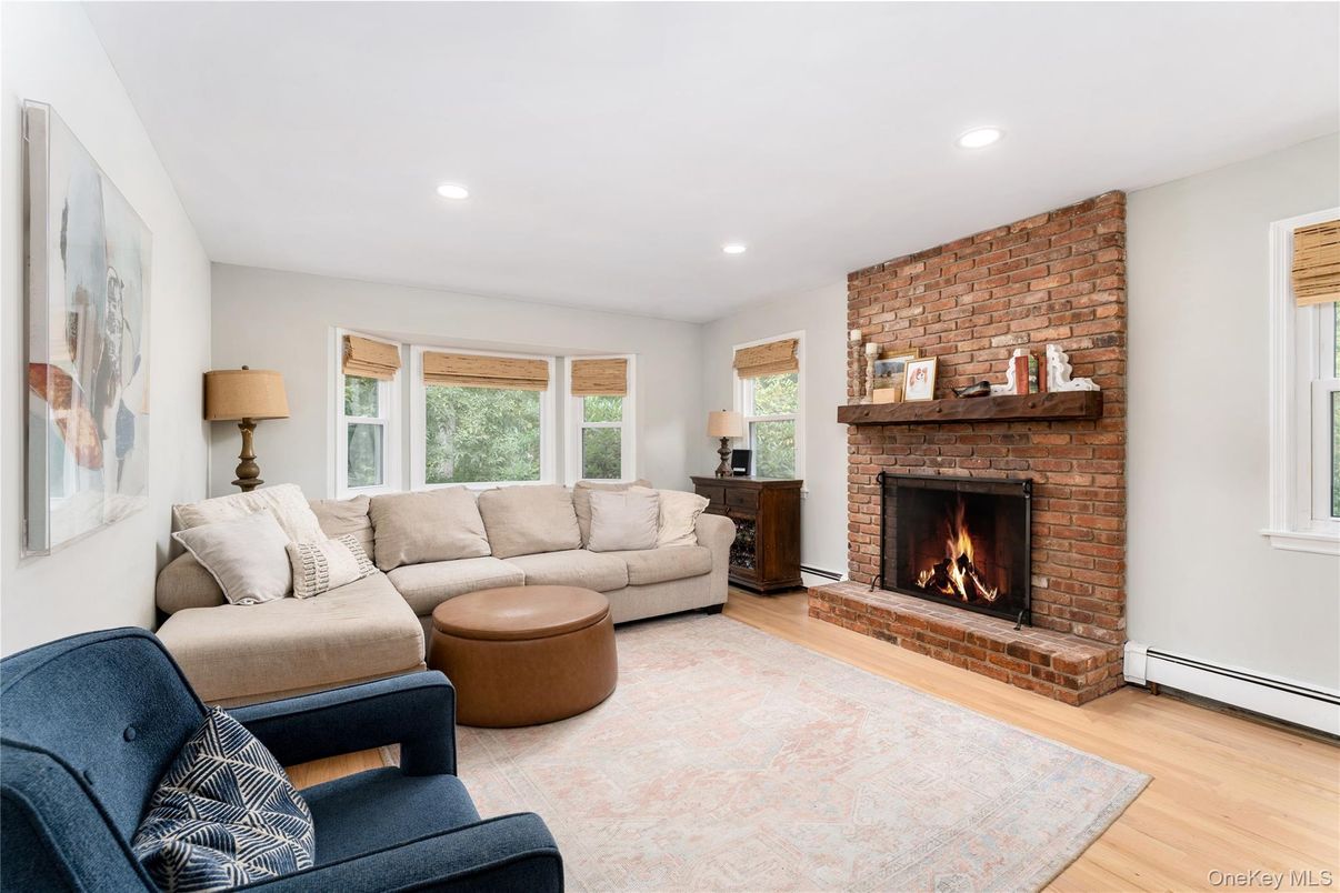 Fireplace, Interior, Living room, Recessed Lighting, Stone Walls, Wood Texture Flooring