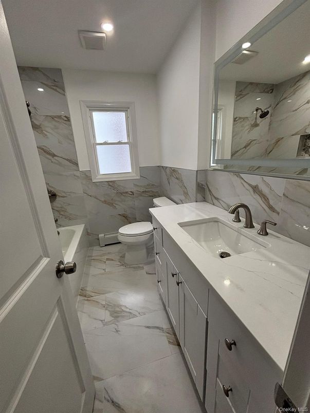 Bathroom, Dual Sink Vanities, Interior, Marble, Marble Walls, Recessed Lighting