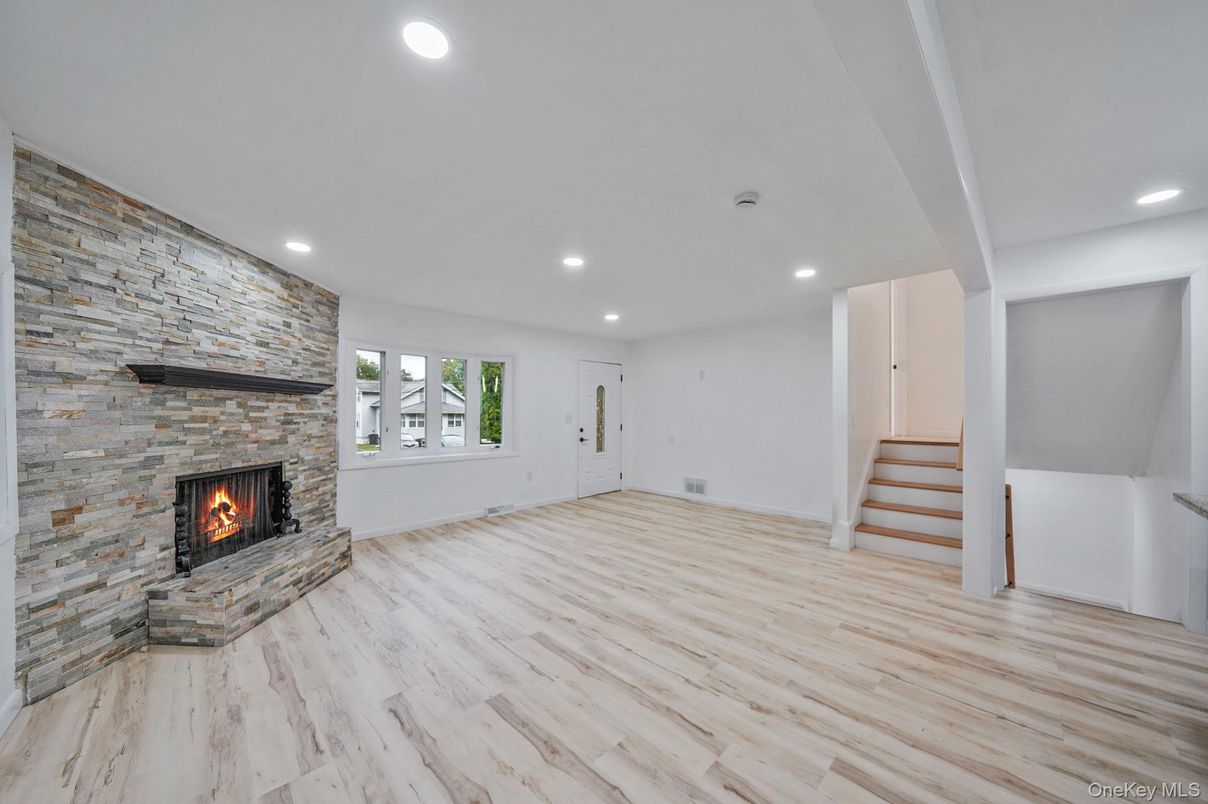 Empty room, Fireplace, Interior, Recessed Lighting, Stone Walls, Wood Texture Flooring