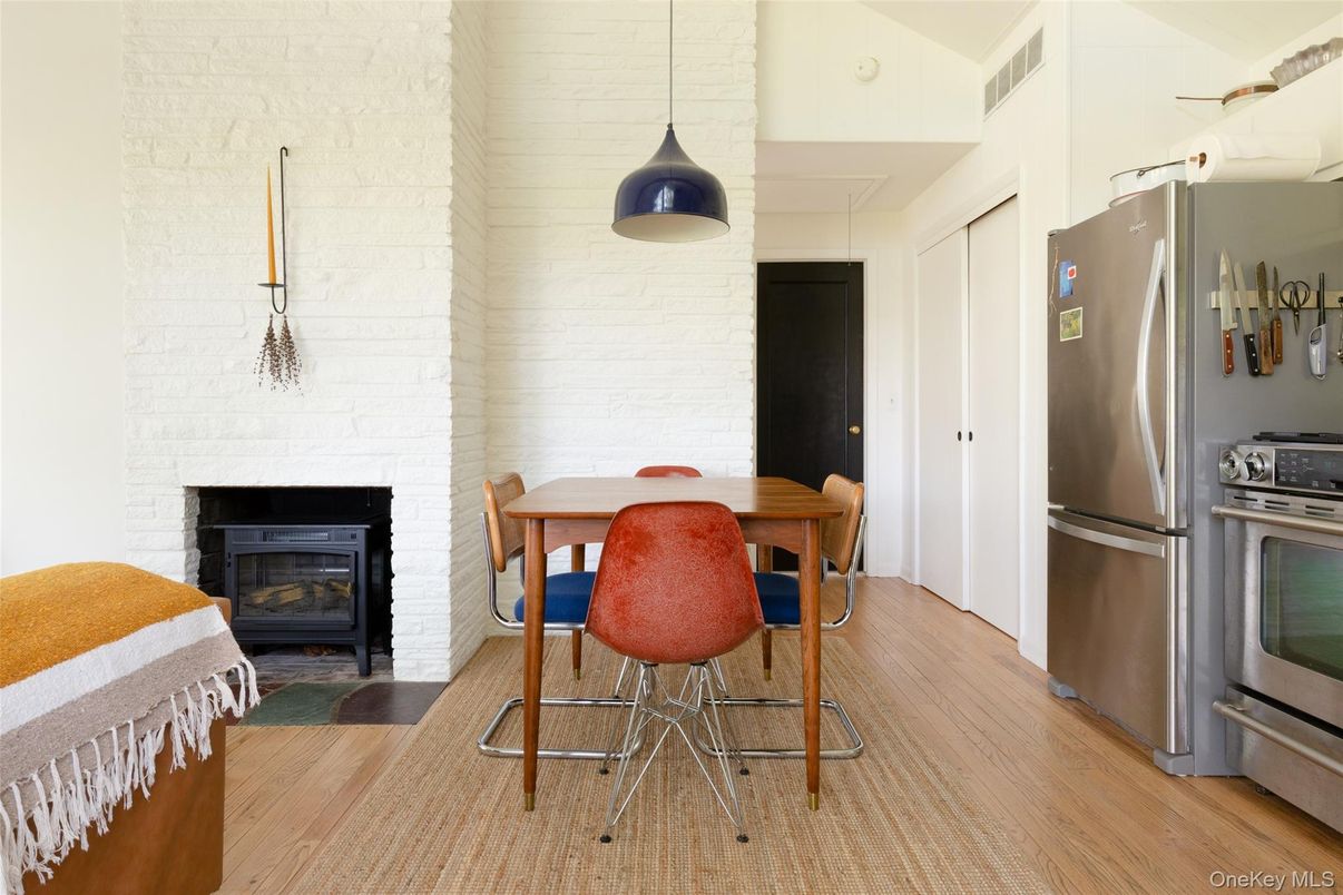 Dining room, Fireplace, Interior, Kitchen, Pendant Lights, Stainless Steel Appliances, Stone Walls, Wood Texture Flooring