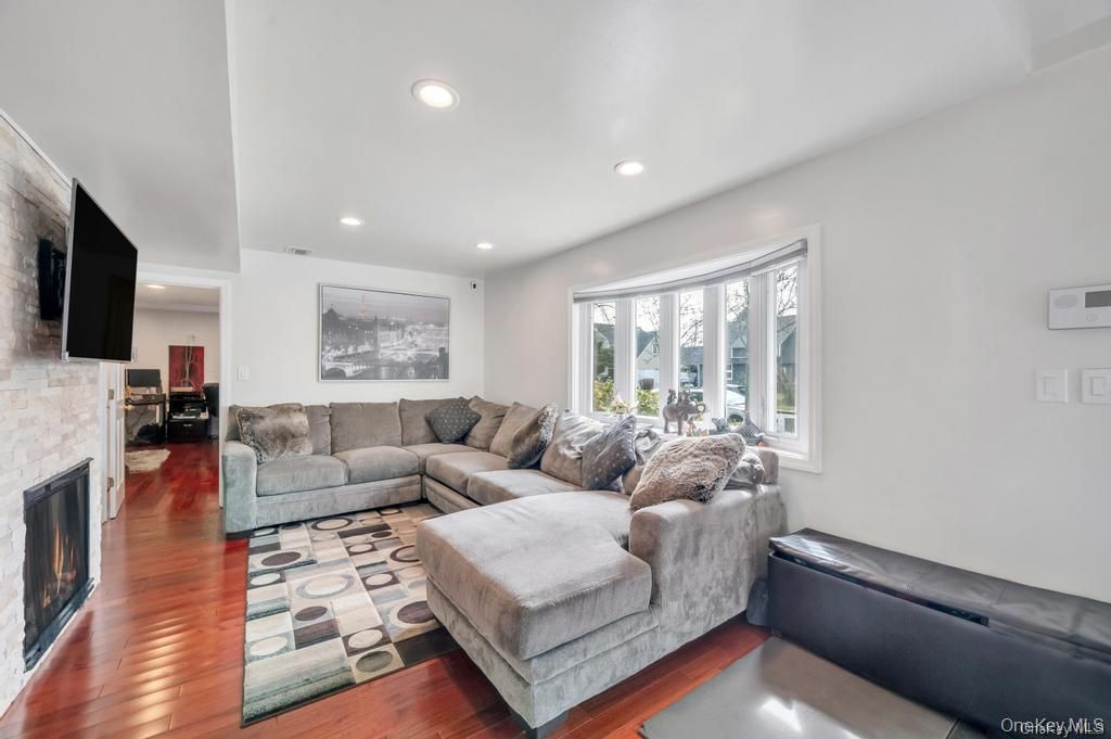 Fireplace, Interior, Living room, Recessed Lighting, Stone Walls, Wood Texture Flooring