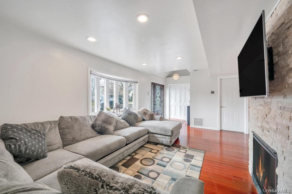 Fireplace, Interior, Living room, Recessed Lighting, Stone Walls, Wood Texture Flooring