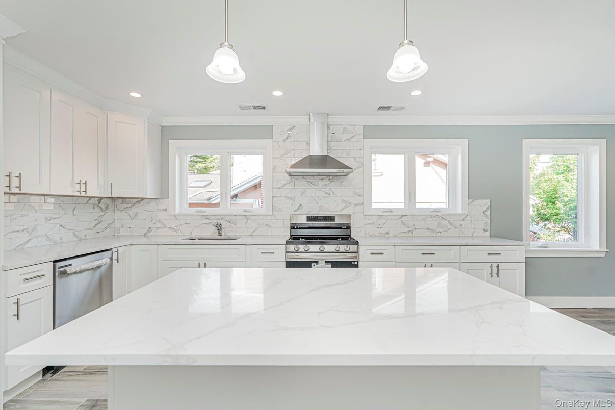 Interior, Kitchen, Marble Walls, Pendant Lights, Recessed Lighting, Stainless Steel Appliances, Wood Texture Flooring