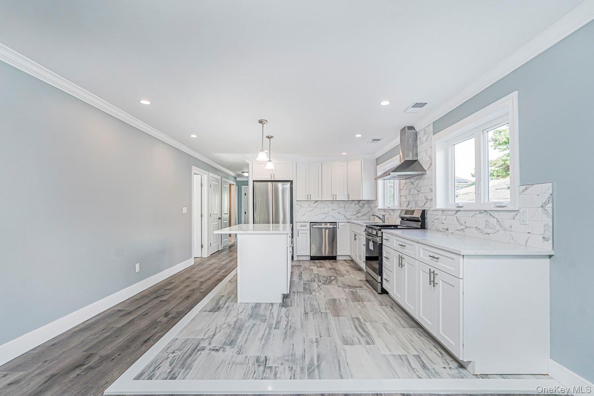 Interior, Kitchen, Marble, Marble Walls, Pendant Lights, Recessed Lighting, Stainless Steel Appliances, Wood Texture Flooring