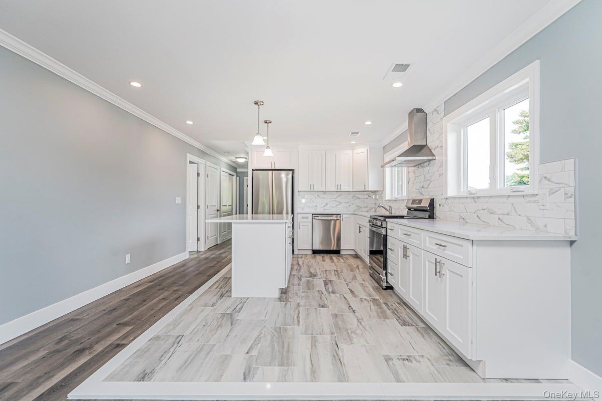 Interior, Kitchen, Marble, Marble Walls, Pendant Lights, Recessed Lighting, Stainless Steel Appliances, Wood Texture Flooring