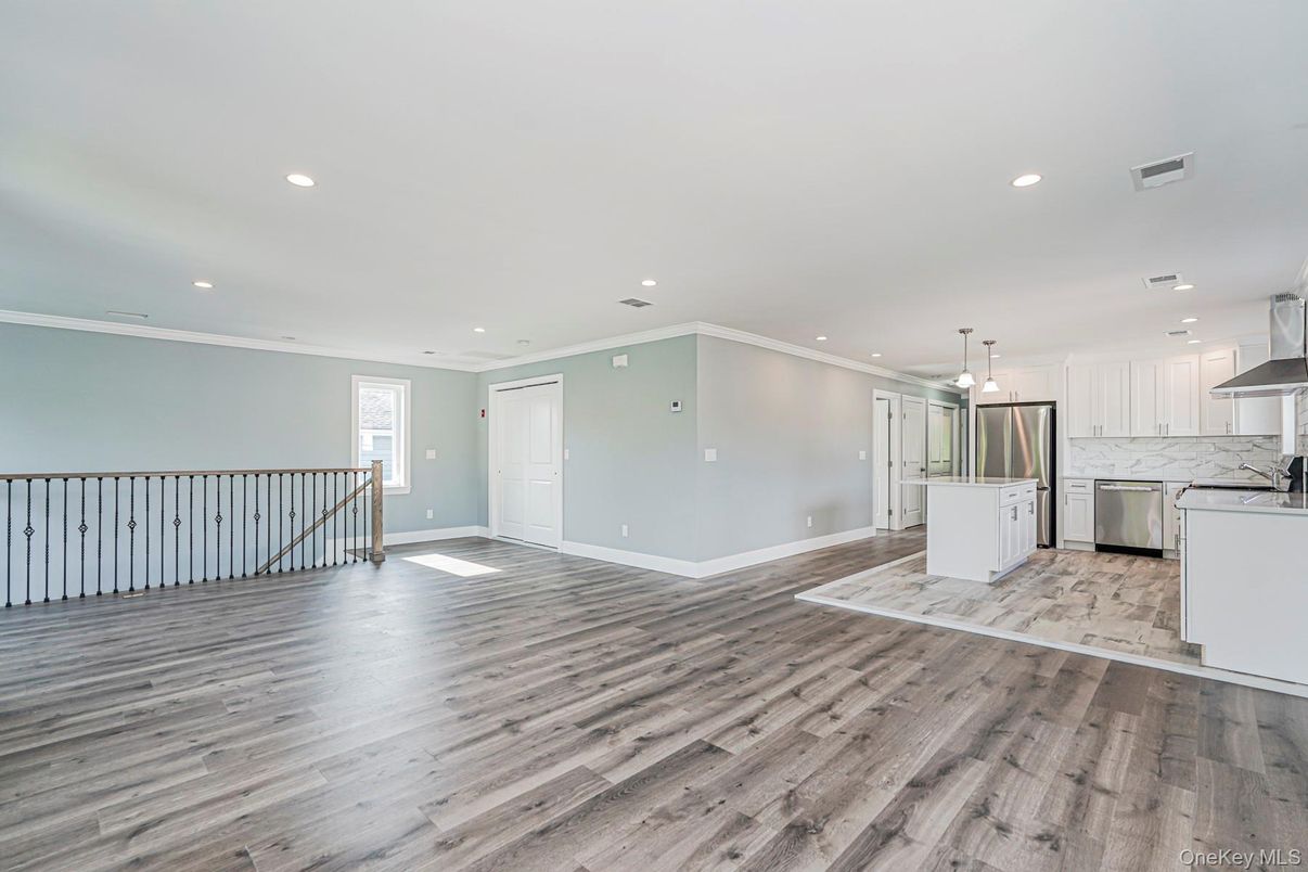 Empty room, Interior, Kitchen, Pendant Lights, Recessed Lighting, Stainless Steel Appliances, Wood Texture Flooring
